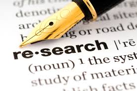 A fountain pen tip points to the word "research" in the dictionary.