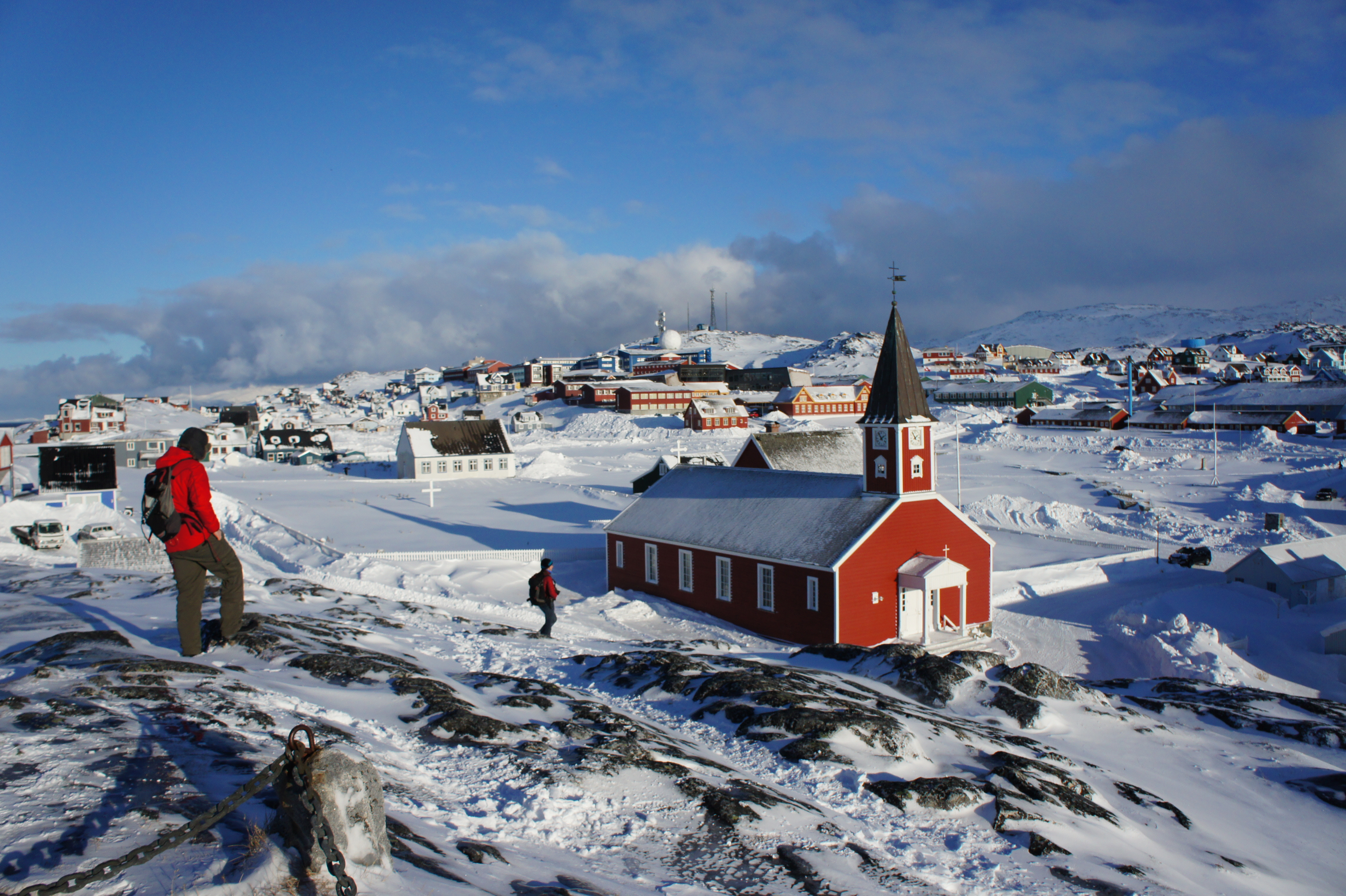 Overlooking Nuuk Old Town from the statue of Nuuk’s founder, Lutheran missionary Hans Egede (not visible, behind photographer). The red Nuuk Cathedral is visible in the mid-ground. Photo credit: Jill Rajewicz