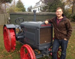 Ian Wereley posing next to a tractor