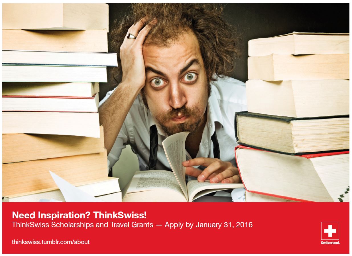 Fatigued looking male, hunched over a table, sandwiched between two piles of books.
