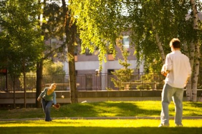 two students in the quad playing catch