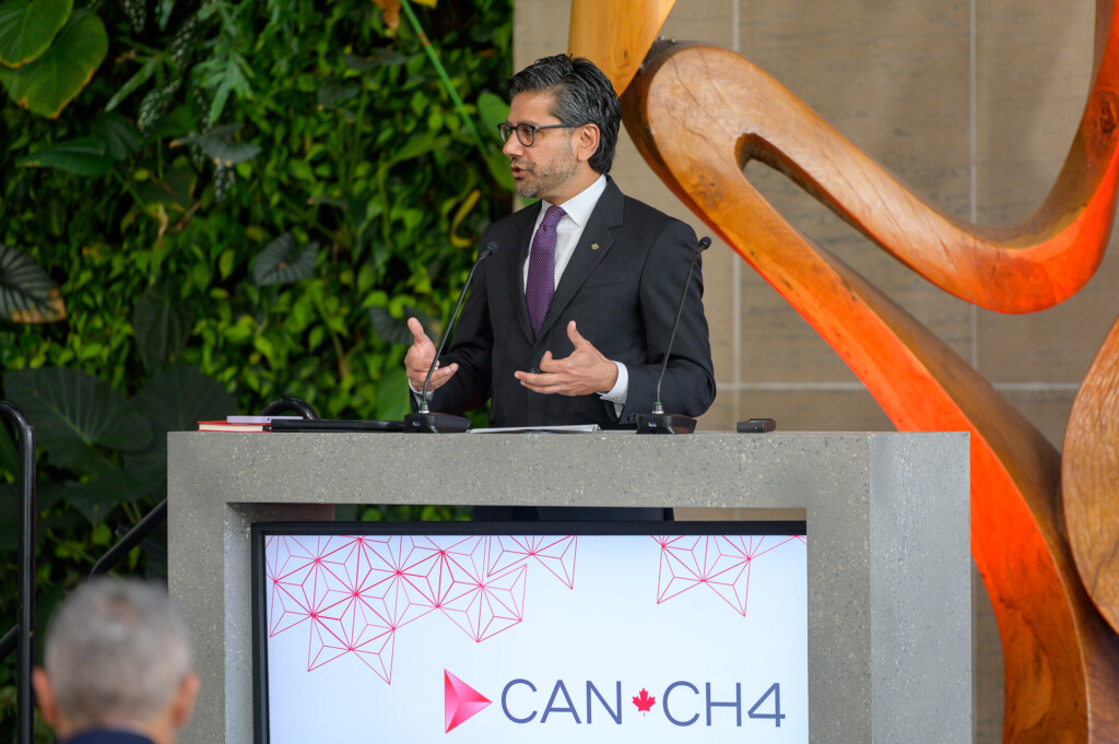 Yasir Naqvi speaking at the podium during opening session.
