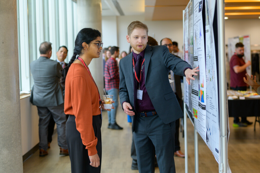 Attendees engaging in poster discussions during CanCH₄ Symposium.