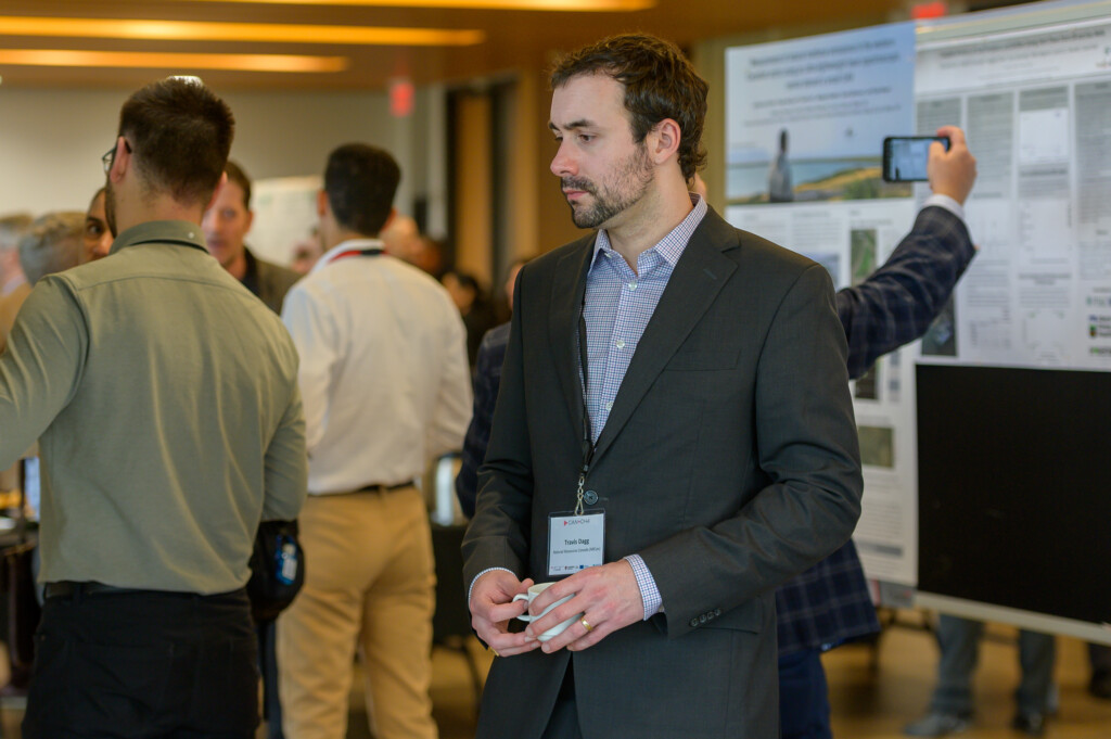 Attendees engaging in poster discussions during CanCH₄ Symposium.