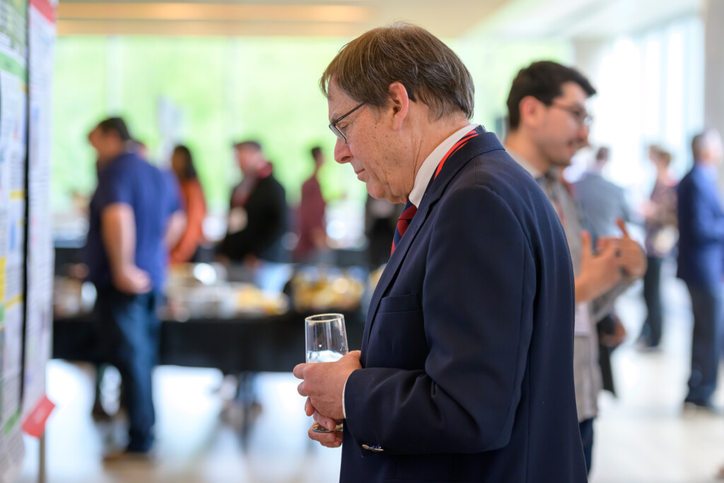 Attendees engaging in poster discussions during CanCH₄ Symposium