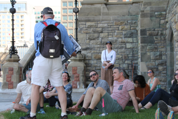 Tour guide leads group on walking tour at Parliament Hill.