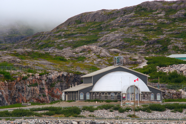 Semi-domed building in rugged, rocky landscape.