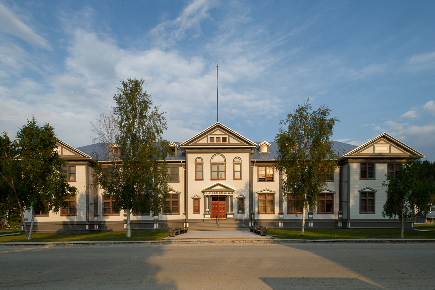 A stately, large symmetrical wooden building in the Classical style.