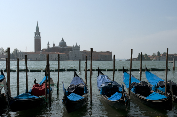 Romantic view of gondolas in the Venetian Laguna, with San Giorgio Magiore in the background.