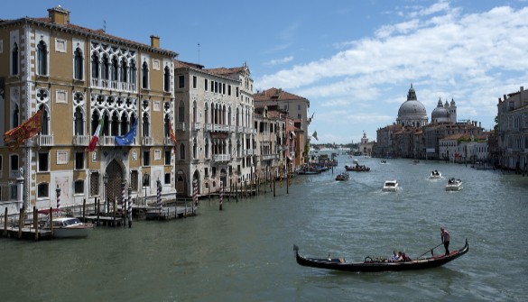 The Grand Canal, with gondola in the foreground and medieval palazzi on the side.