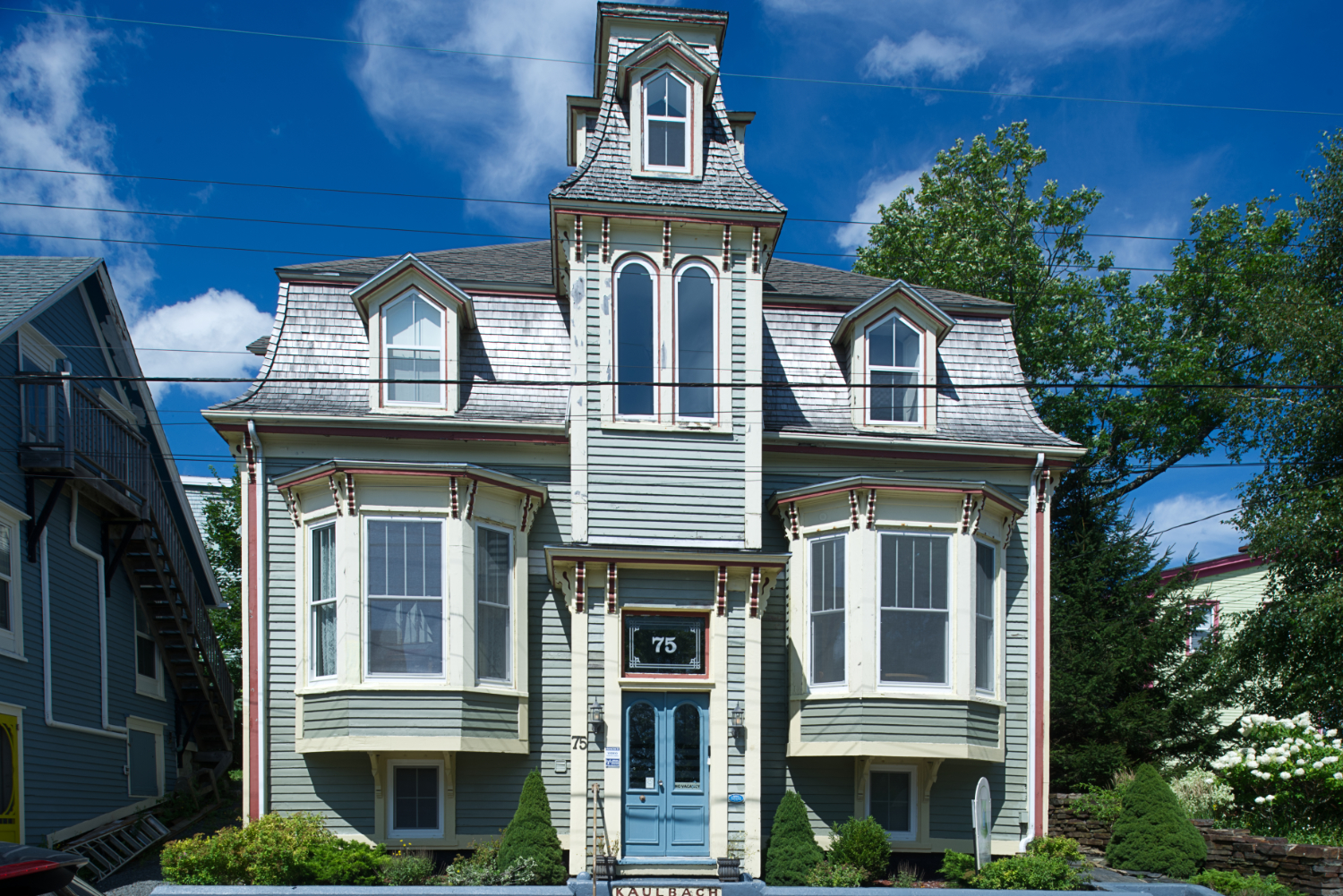An ornate Victorian wooden building on a street in Lunenburg.