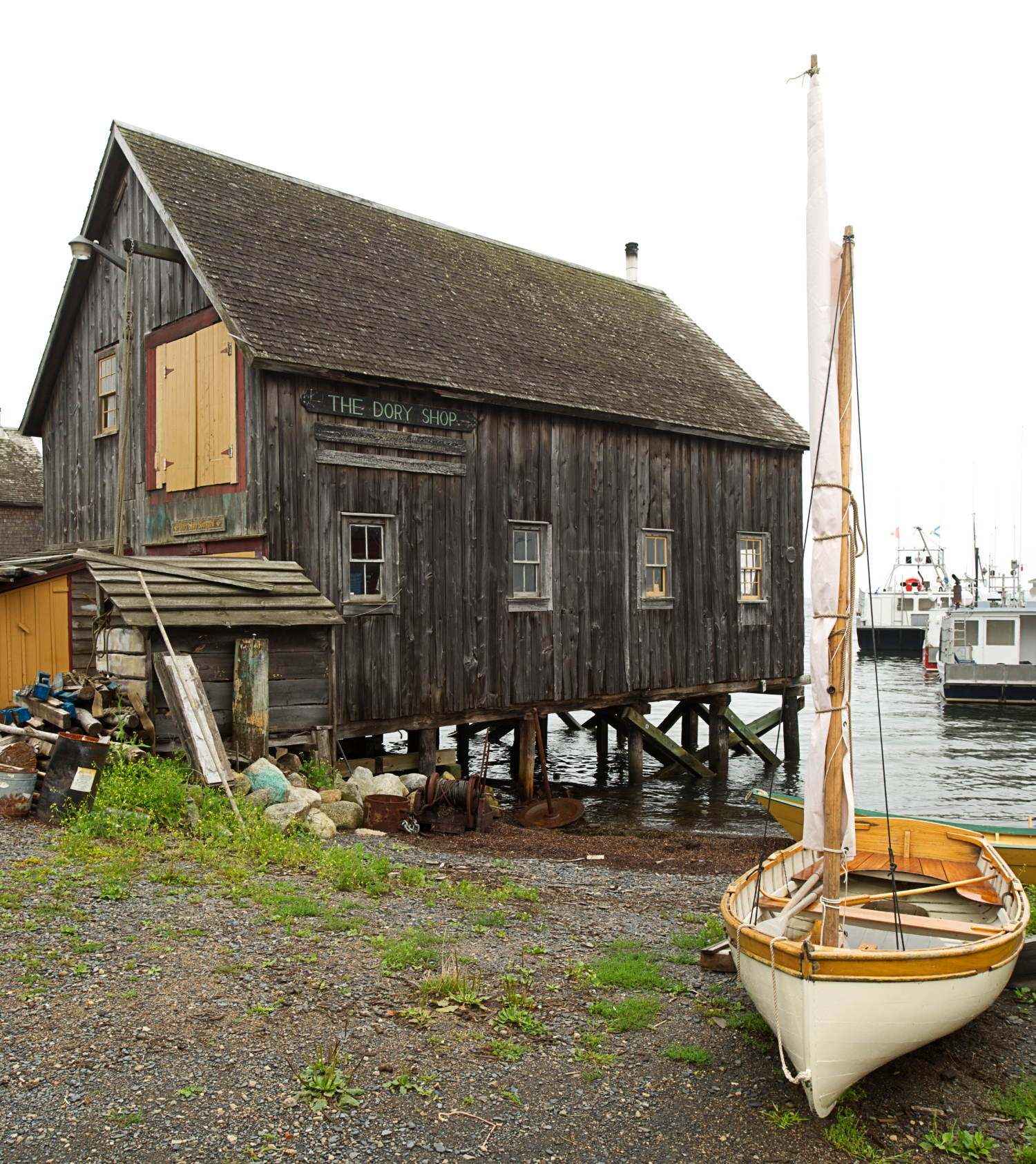 A rustic wooden shed is perched on the edge of Lunenburg Harbour.