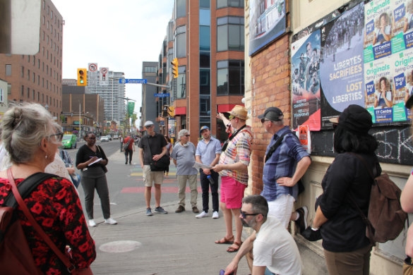 Tour guide leads group during Small Modernisms symposium.