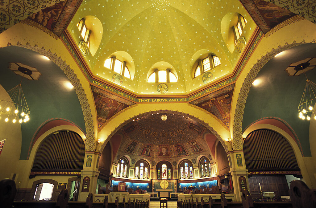 A lofty domed space ornamented with painted murals and low-relief sculpture.