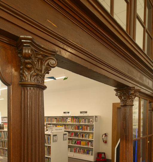 Interior of Rosemount Library, showing carved wooden Corinthian capitals supporting an entablature.