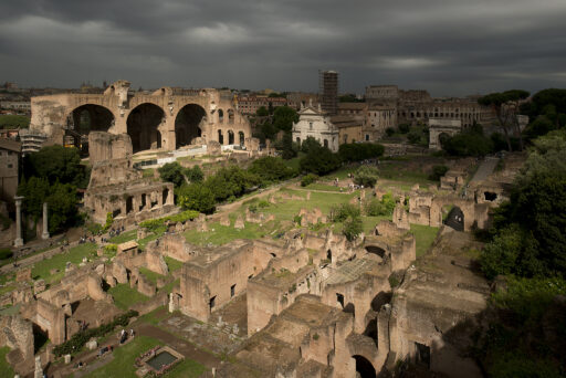 A view of ancient Roman ruins in the distance.