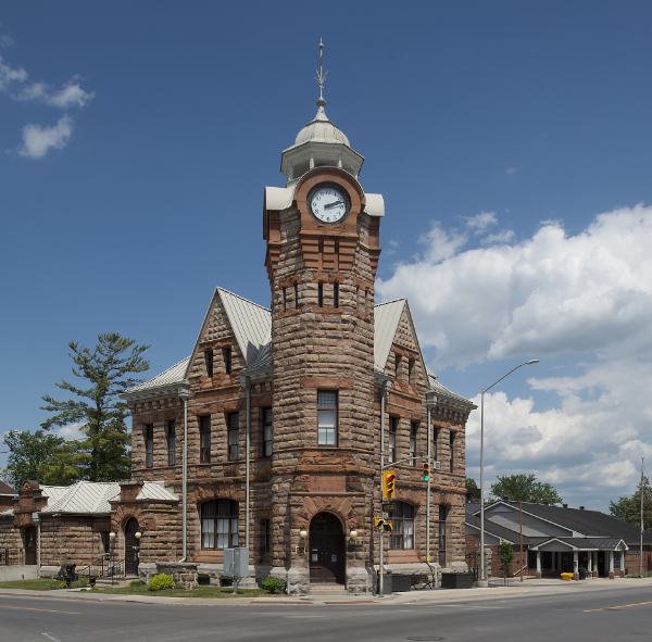 Red sandstone building with corner tower.