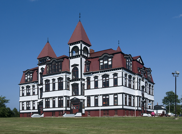 White and red wooden Victorian building.