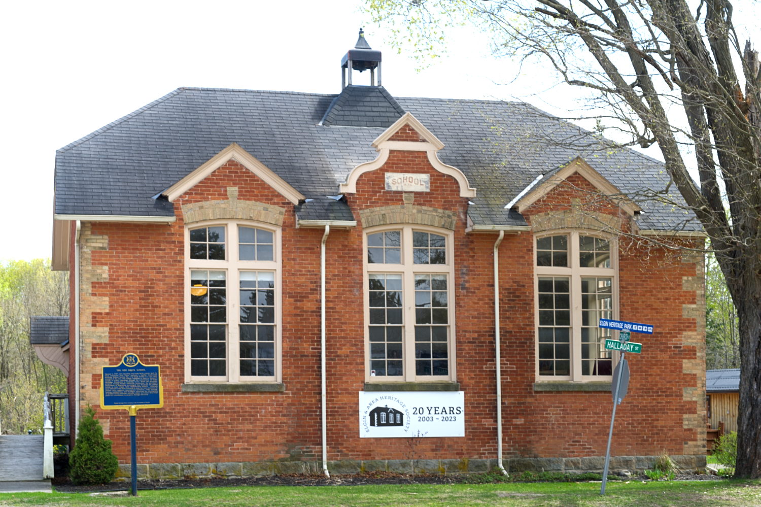 A small but nicely detailed red and yellow brick schoolhouse.