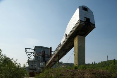 A very long and large square tube extends from the back of the dredge.