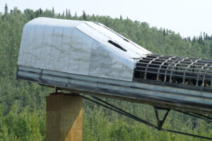 A large square tube suspended above the landscape.