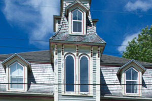 Detail of the front of an ornate Victorian wooden house.