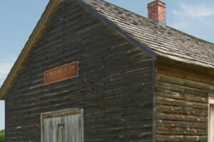 Detail of log building and church signage.