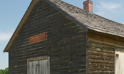 Detail of log building and church signage.