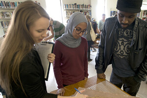 Three students engaged in work.