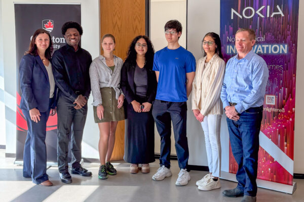 Nokia VP Transformation and Site Lead, Andy Thompson (right), with Carleton University Chief Advancement Officer, Corrie Hobin (left) and student award recipients at the official partnership announcement event.