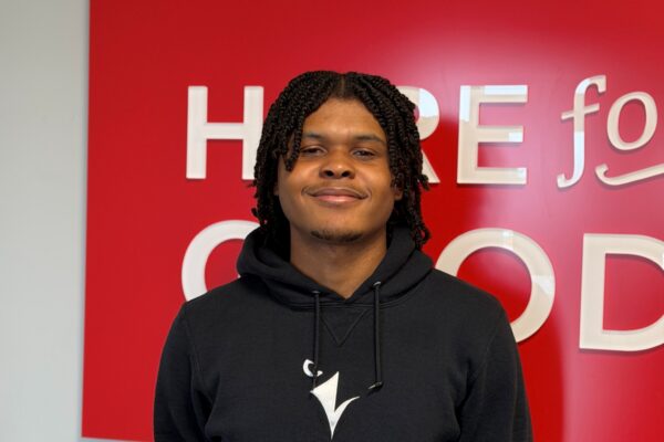 Daniel King smiles in a Ravens sweater