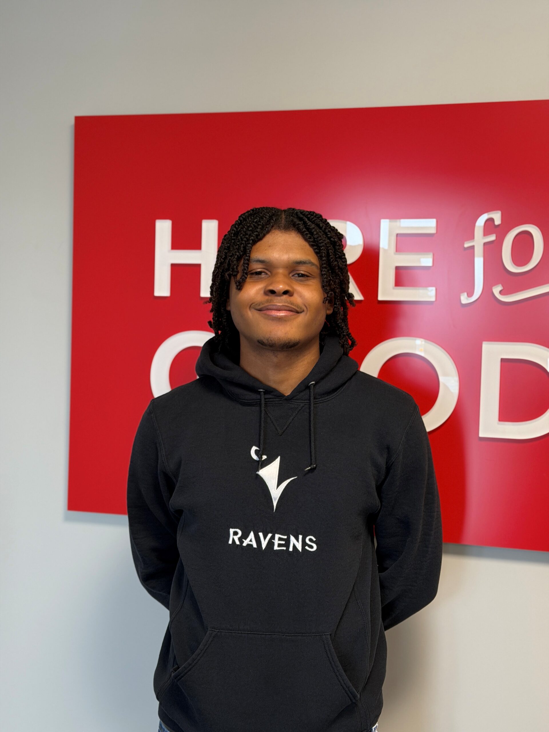 Daniel King smiles in a Ravens sweater