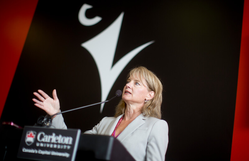 Jennifer Brenning speaks at a podium