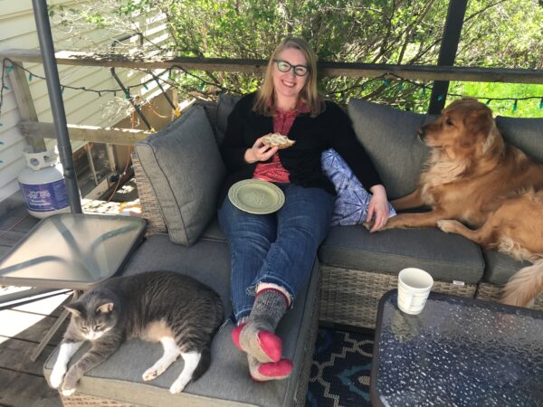 Susan sits outside with her pets Charlie and Stella