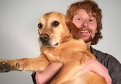 Landon Arbuckle holding his dog.