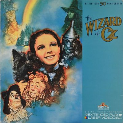 A photo of the 50th anniversary Wizard of Oz laserdisc, which is blue and decorated with painted images of characters from the movie.