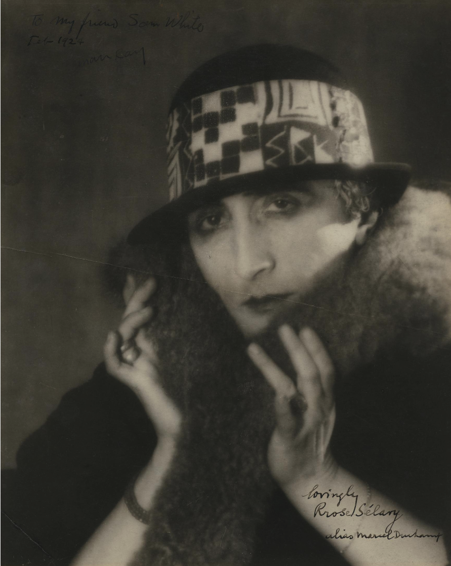 Black and white image of a woman in a hat and fur coat.