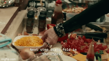 Gif of David and mother cooking. Mother says the next step is to "fold in the cheese" and David asks "what does fold in the cheese mean"