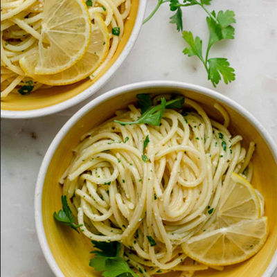 Overhead picture of 2 bowls of lemon pasta with cilantro sprinkled on top.
