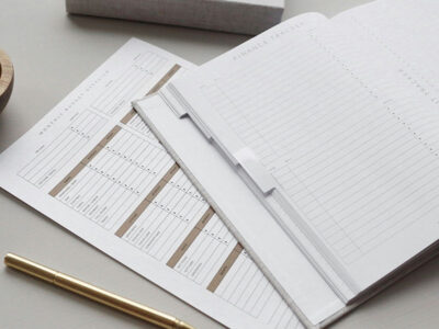 Image of a budget sheet listing expenses, with a finance journal for tracking purchases on top