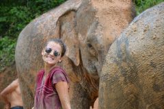 Image of student with an elephant while on an International Placement in Thailand 