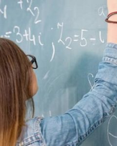 person writing on a chalkboard
