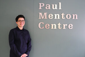 Frohan Foroutan, the 2019 Board Award Recipient standing in front of the entrance to the Carleton University Paul Menton Centre for Students with Disabilities.