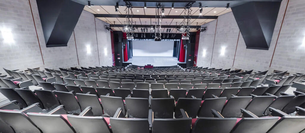 A view of the seating arrangements and stage inside the Kailash Mital Theatre.