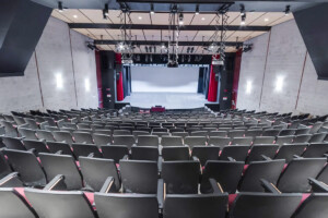 A view of the seating arrangements and stage inside the Kailash Mital Theatre.