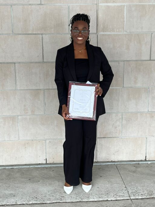 Nimi Tella, a 4th year undergraduate Civil Engineering student holding her Kipling Award certificate