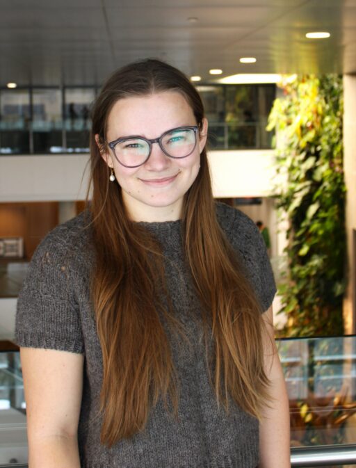 Ph.D. candidate Isabella Hearne's poses for a headshot at the top floor of Richcraft Hall.