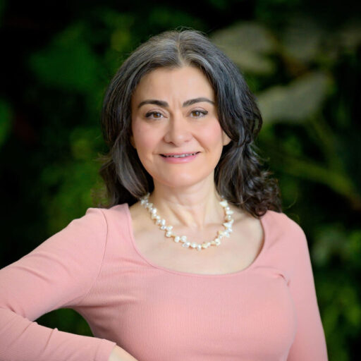 Professor Banu Ormeci's headshot. She is looking in the camera, smiling while wearing a pink long-sleeved top.