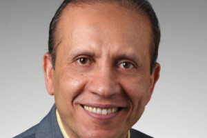 Image of Yasser Hassan wearing a yellow shirt