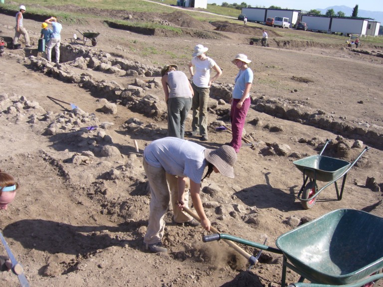 Students excavate rubble wall features and Roman roads in Italy
